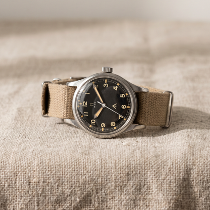 Field watch with khaki canvas strap on linen